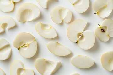 Freshly sliced apples arranged on a white surface