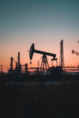 Industrial Oil Extraction at Sunset A Stunning View of Oil Pumps Silhouetted Dramatically Against a Vibrant Sky