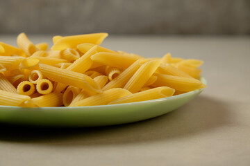 Freshly cooked penne pasta ready to be enjoyed on a rustic table setting