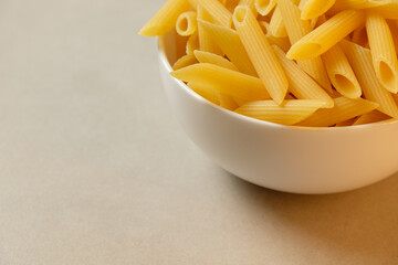 Perfectly cooked penne pasta in a clean white bowl ready for a meal
