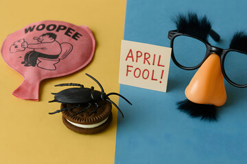 Colorful April Fool's Day prank props on split background  