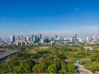 Aerial view modern office building with tropical green tree park in Benchakitti public park downtown