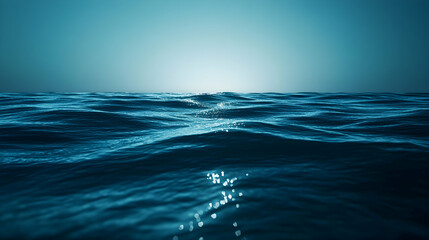 Obraz premium Blue ocean waves reflecting sunlight creating a serene seascape and calming nautical ambiance