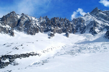 Sharp mountains in the glacier of the Valle Blanche photographed from the Aiguille du Midi at the foot of Mont Blanc