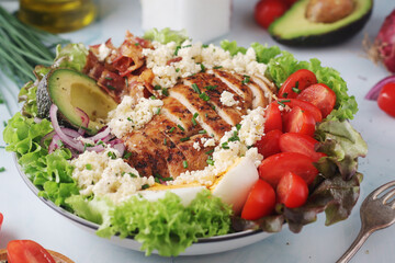 A bowl with cobb salad, traditional American dish