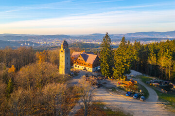 A clear sunny autumn morning highlights the Bramberk lookout tower and adjacent hut nestled in the...