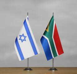 Table flags of Israel and South Africa on grey blurred background