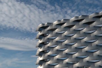 modern texture with galvanized steel useful anti-rust. Detail of a building facade in expanded metal panels of steel composed of modular elements perforated and elongated to make it stronger