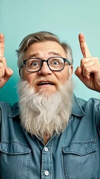 Enthusiastic bearded man gesturing ideas in denim shirt against turquoise backdrop