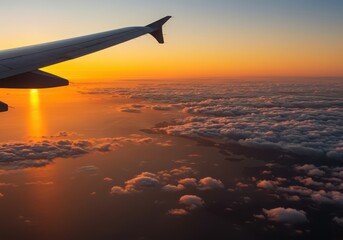 Obraz premium View from airplane window with wing over clouds during golden sunset, peaceful sky and horizon scene