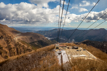 Akechidaira ropeway with surrounding beautiful viewpoints in Nikko, Japan, during cold weather in winter under cloudy blue sky