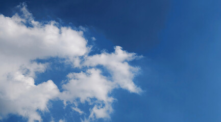 Bright Blue Sky with Fluffy White Clouds in Clear Daytime Atmosphere