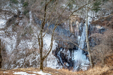 Kegon waterfall in Nikko, The UNESCO World Heritage city, Japan, became snow and ice in winter season under cloudy blue sky