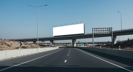 Highway view with billboard and overpass under a clear blue sky on a sunny day in the countryside
