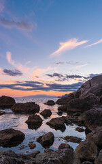 Sudak, Crimea Peninsula. View of the rocky shore of the Black Sea in the sunset light.