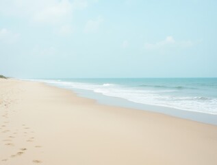 Fototapeta premium Serenity on the Beach: Footprints in the Sand