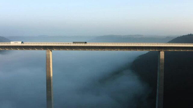 Drone aerial video of the bridge carrying the A6 autobahn at sunrise over the Kocher River valley in Germany
