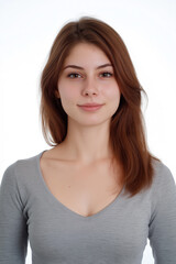 Obraz premium The image is a tightly framed, close-up portrait of a young woman against a pure white background. The focus is sharp on the face and upper chest, with a shallow depth of field. The subject has