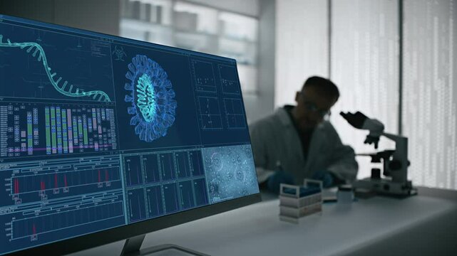 Male scientist working in a futuristic science laboratory with a microscope. Computer display showing the virus mutations