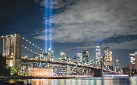 Night view during 9 11 of lower Manhattan and the Brooklyn Bridge with the Tribute in Light in the background