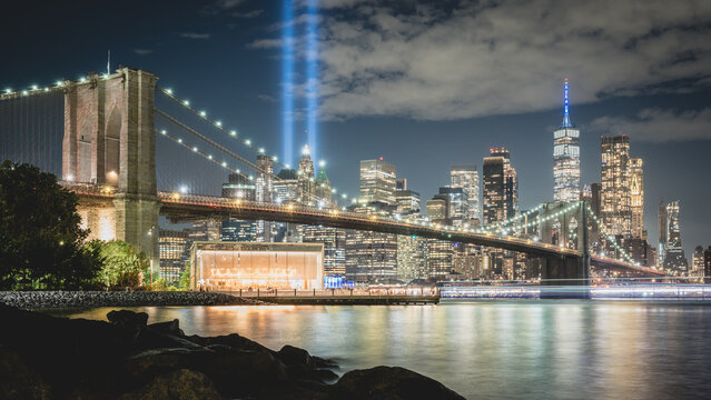 Night view during 9 11 of lower Manhattan and the Brooklyn Bridge with the Tribute in Light in the background
