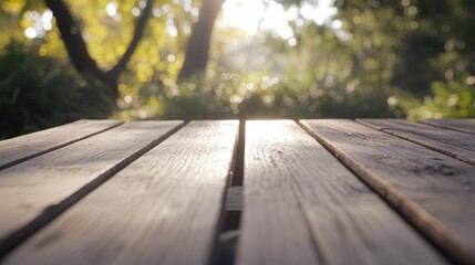 Rustic wood picnic table in a park setting with sunlight and green foliage