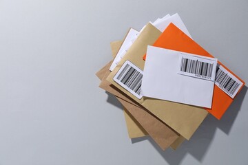 Post office. Different paper envelopes on light grey background, top view. Space for text