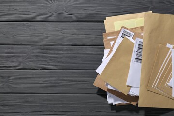 Post office. Different paper envelopes on grey wooden table, top view. Space for text