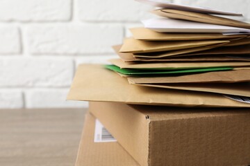 Post office. Different paper envelopes and parcels on table, closeup. Space for text