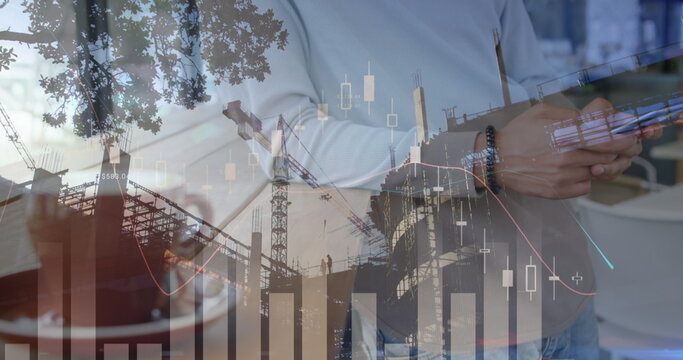 Image of statistics and data processing over construction site and businessman using smartphone