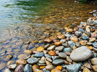 stones at the calm lake side
