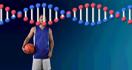 Image of dna strand over male basketball player holding ball