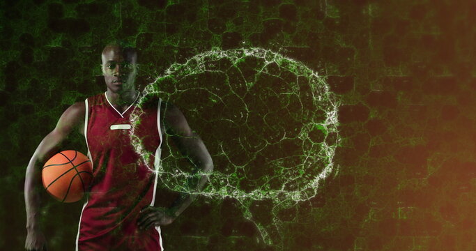 Image of digital brain spinning over male basketball player holding ball - Powered by Adobe