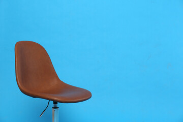 Comfortable office chair on light blue background, space for text