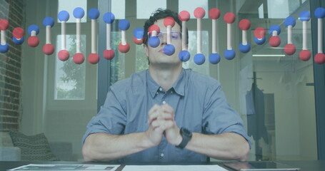 Image of dna strand over businessman in office