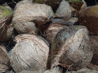 A collection of partially peeled coconuts