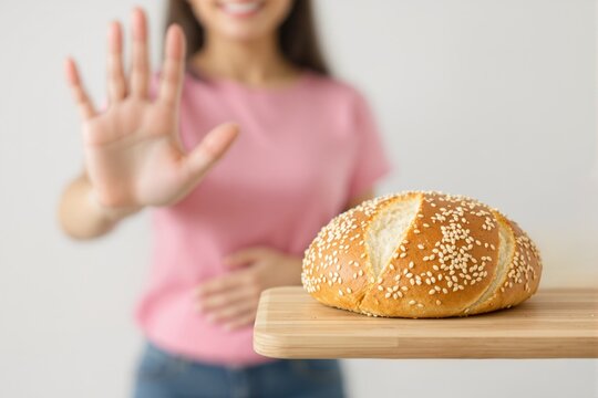 Woman refusing sesame seed bread with hand gesture, soft focus style, on light background. Concept of gluten-free or low-carb diet. Ai generative