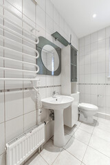 Modern bathroom interior with white fixtures and tiled walls. Clean and minimalist design.