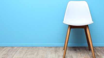 A White Modern Chair Stands Alone Against a Blue Wall