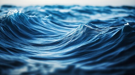 A 3d illustration depicting smooth flowing waves with blue metallic reflections, creating an abstract liquid metal effect.
