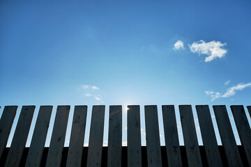 Privacy and security are provided by a rustic wooden fence