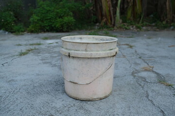 Used plastic pail on ground