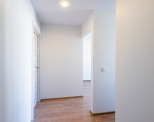 Bright Empty Room With Wooden Flooring and Door. White Walls Room Corner. Door