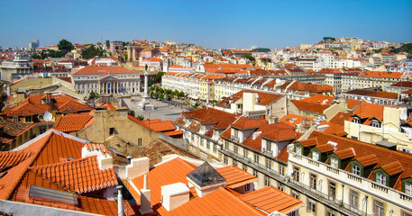Lisbon, Portugal. Rossio aka Dom Pedro IV Square with Dona Maria II Theatre and Baixa District old historical buildings with terracotta rooftops