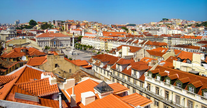 Lisbon, Portugal. Rossio aka Dom Pedro IV Square with Dona Maria II Theatre and Baixa District old historical buildings with terracotta rooftops