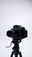 Vintage Camera on Tripod: Classic medium format camera on a tripod, capturing the timeless beauty of photographic equipment.