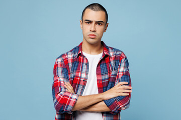 Young sad frowning mad middle eastern man he wear red shirt casual clothes hold hands crossed...