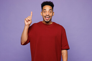 Young smart proactive man of African American ethnicity wear red t-shirt casual clothes holding...