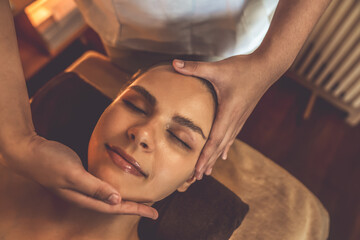Closeup caucasian woman enjoying relaxing anti-stress head massage and pampering facial beauty skin...