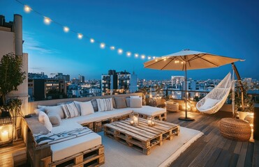 Fototapeta premium A large rooftop terrace with wooden pallets, white furniture, and fairy lights overlooking the city at night